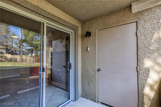 entrance to property with stucco siding