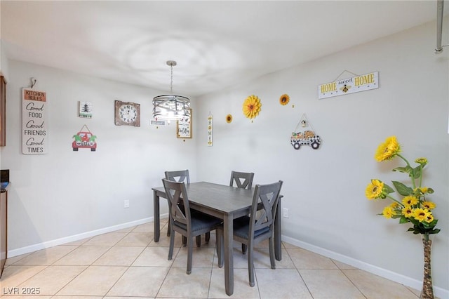 dining area featuring light tile patterned floors and baseboards