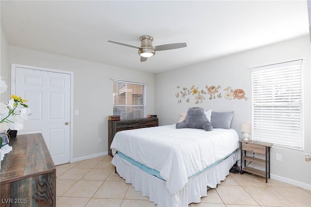 bedroom with a ceiling fan, baseboards, and light tile patterned floors