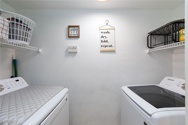 washroom featuring laundry area and washing machine and clothes dryer