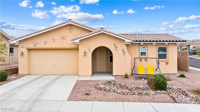 view of front of property with a garage, driveway, a tile roof, and stucco siding