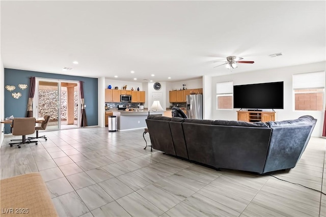 living area with recessed lighting, visible vents, ceiling fan, and light tile patterned floors