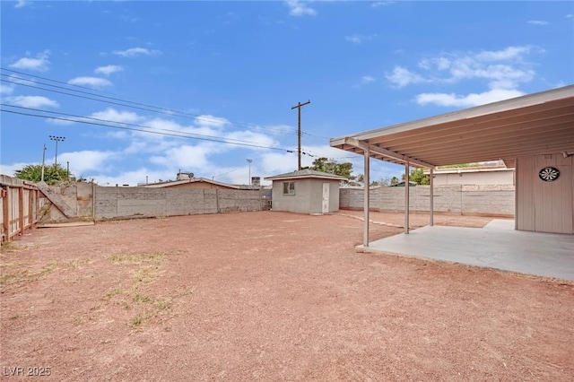 view of yard featuring an outbuilding, a patio, and a fenced backyard