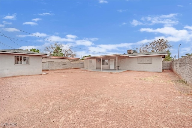 back of property with a patio area, a fenced backyard, and stucco siding