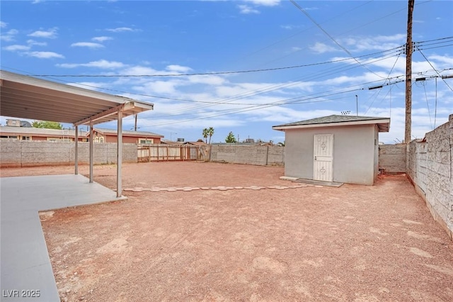 view of yard featuring an outbuilding, a fenced backyard, a patio, and a storage shed