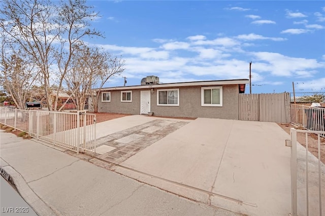 ranch-style home featuring a patio area, fence, and stucco siding