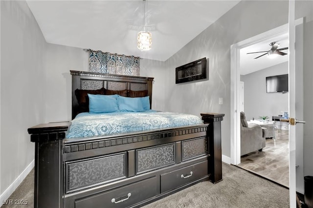 bedroom featuring carpet, baseboards, and vaulted ceiling