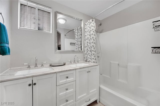 full bathroom featuring shower / bath combination with curtain, double vanity, and a sink