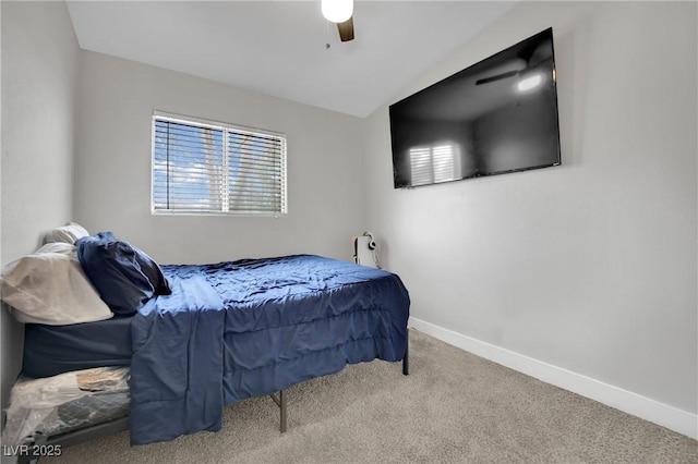 bedroom featuring lofted ceiling, carpet, baseboards, and ceiling fan