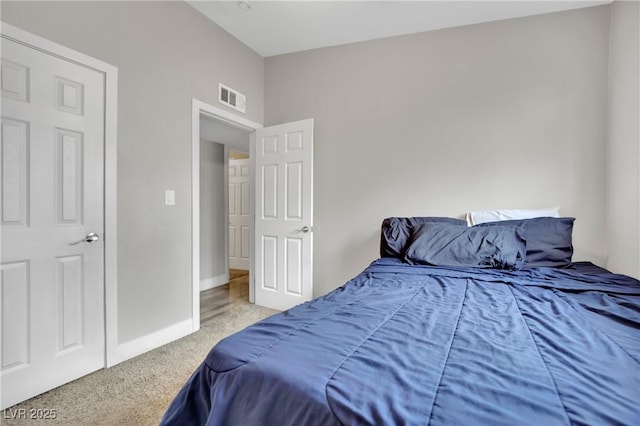 carpeted bedroom with visible vents and baseboards