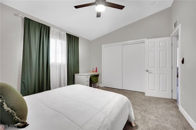 bedroom with baseboards, a ceiling fan, vaulted ceiling, carpet floors, and a closet