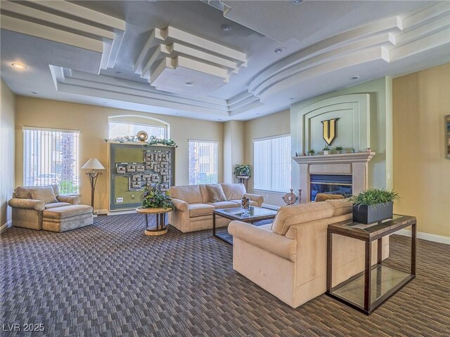 7111 S Durango Dr Unit 305, Las Vegas, NV 89113 - living room with a glass covered fireplace, dark colored carpet, healthy amount of natural light, and recessed lighting