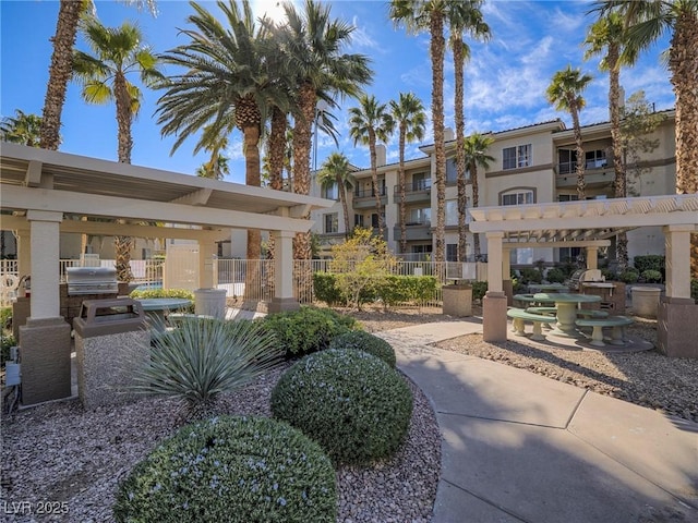 surrounding community featuring fence and area for grilling