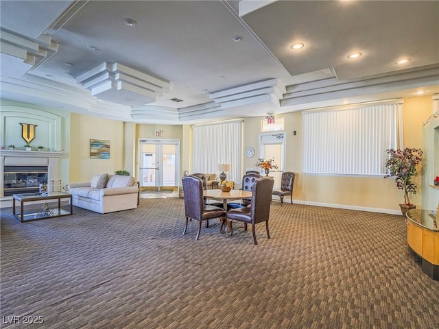 dining space with french doors, recessed lighting, a glass covered fireplace, carpet flooring, and baseboards