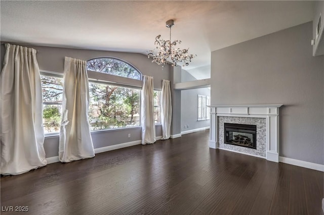 unfurnished living room featuring a fireplace, baseboards, vaulted ceiling, and wood finished floors