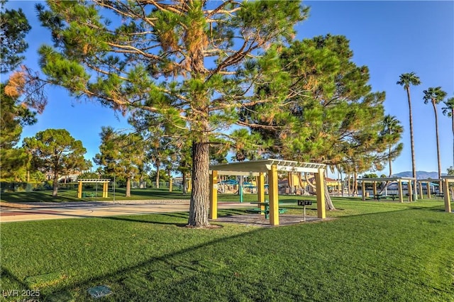 view of play area with a yard and a pergola