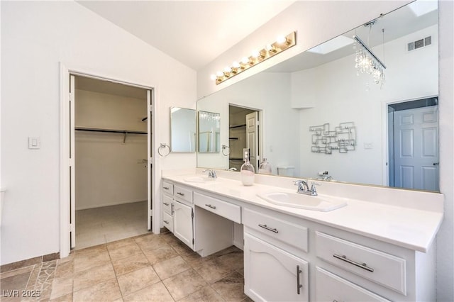 full bathroom with lofted ceiling, double vanity, visible vents, and a sink