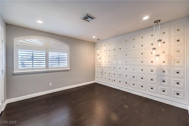 spare room with recessed lighting, dark wood-style flooring, visible vents, and baseboards