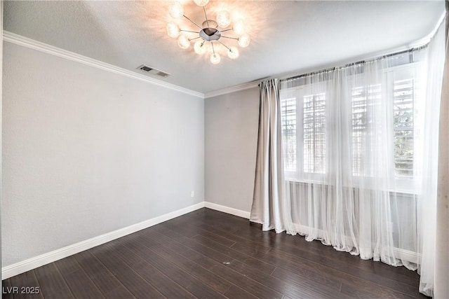 spare room with crown molding, baseboards, dark wood finished floors, and a textured ceiling