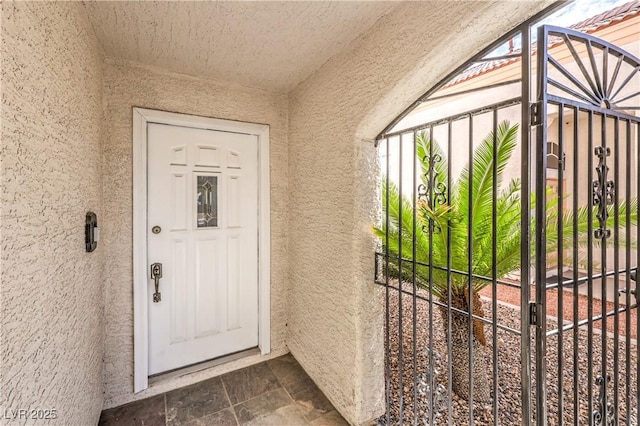 doorway to property featuring stucco siding