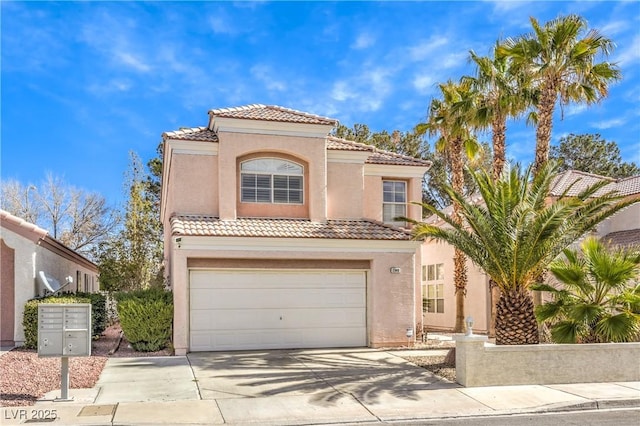 mediterranean / spanish home featuring a garage, driveway, a tiled roof, and stucco siding