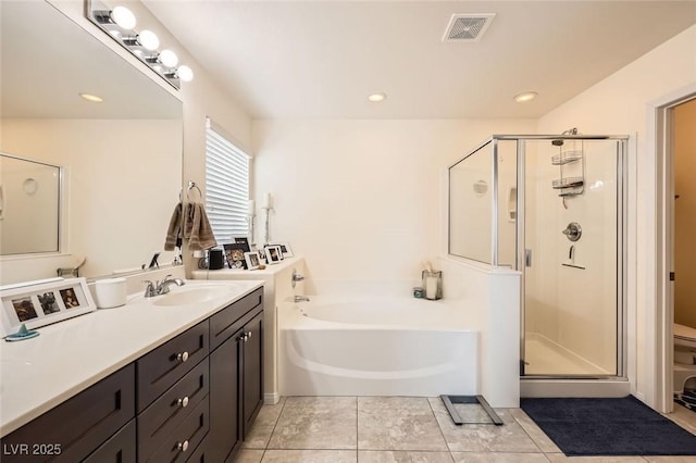 bathroom with recessed lighting, vanity, visible vents, a bath, and a stall shower