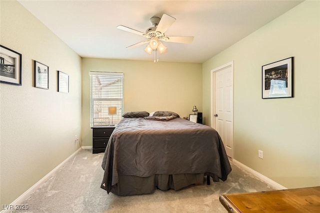 bedroom featuring baseboards, a ceiling fan, and light colored carpet