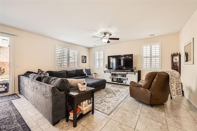 living room featuring visible vents, ceiling fan, and light tile patterned flooring