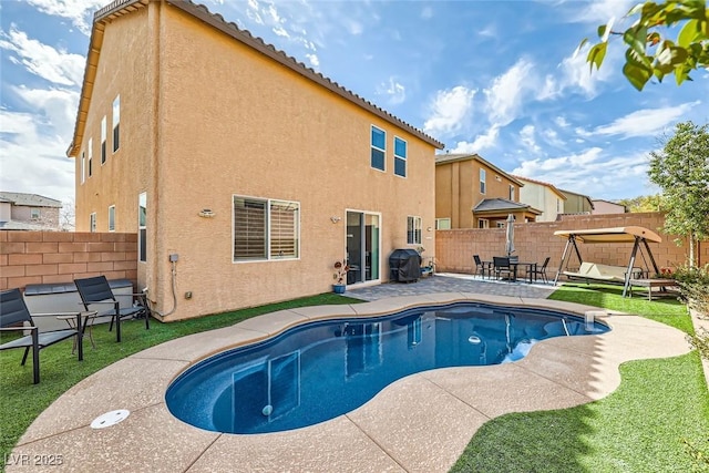 view of swimming pool with a fenced in pool, a patio area, a grill, and a fenced backyard