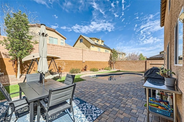 view of patio with a fenced backyard and outdoor dining area