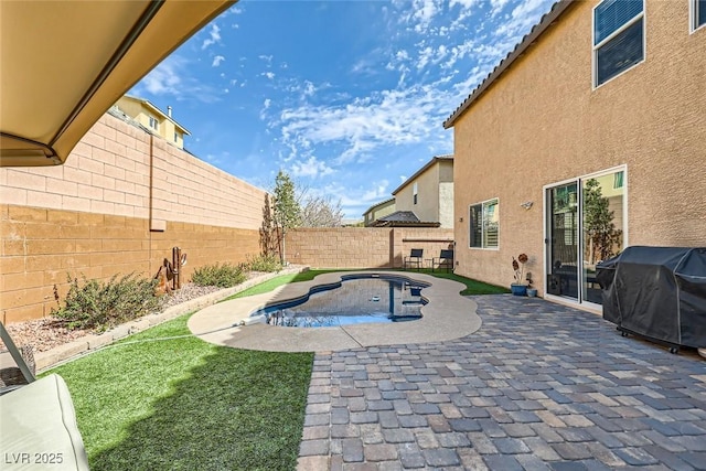 view of pool with a patio area, a grill, a fenced in pool, and a fenced backyard