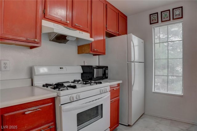 kitchen with light countertops, white appliances, a healthy amount of sunlight, and under cabinet range hood