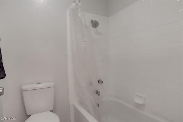 bathroom with shower / bath combo with shower curtain and toilet