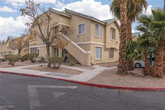 view of front of home featuring a tiled roof and stucco siding