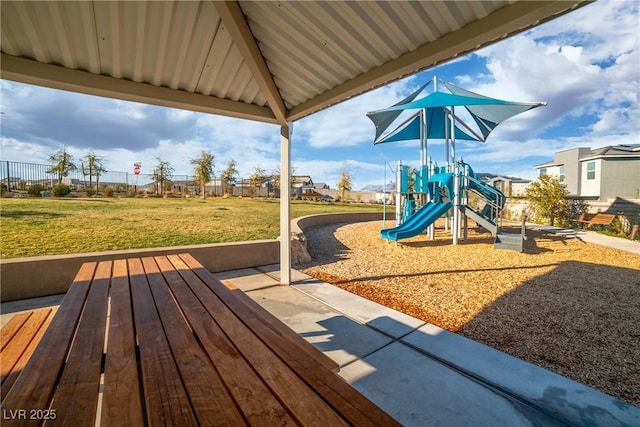 communal playground with a yard and fence