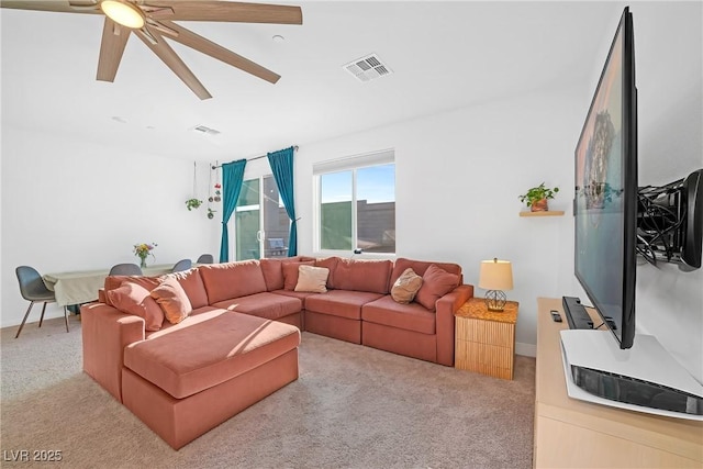 living room with visible vents, light colored carpet, and ceiling fan