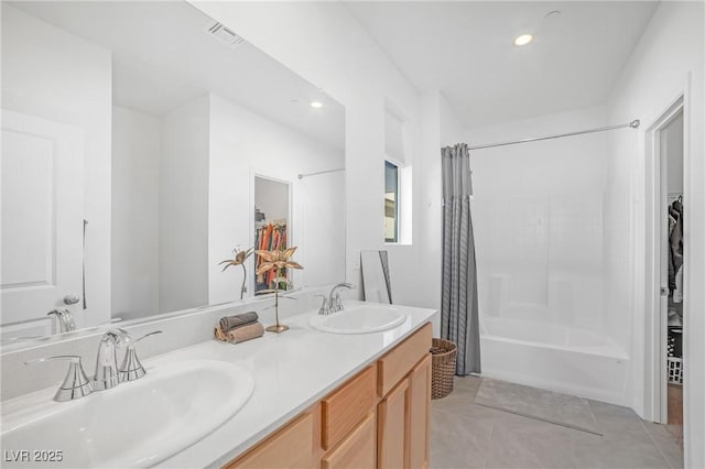 full bath featuring tile patterned flooring, a spacious closet, visible vents, and a sink