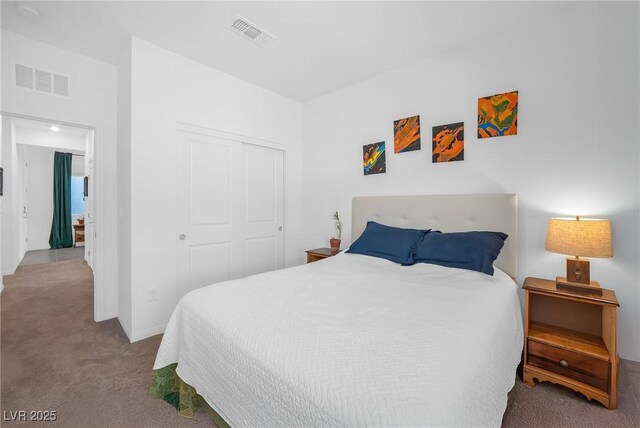 bedroom featuring a closet, visible vents, and carpet floors