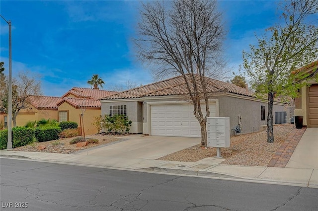 mediterranean / spanish-style home with concrete driveway, a tile roof, an attached garage, and stucco siding