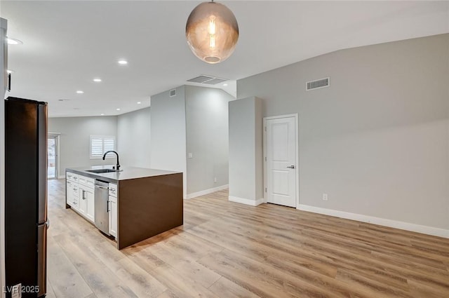 kitchen with visible vents, appliances with stainless steel finishes, light wood-style flooring, and a sink