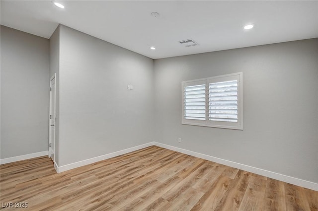 unfurnished room featuring recessed lighting, baseboards, visible vents, and light wood finished floors