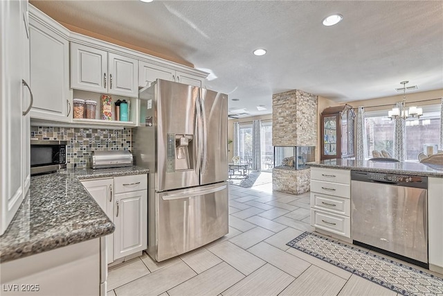 kitchen featuring recessed lighting, a fireplace, visible vents, appliances with stainless steel finishes, and backsplash