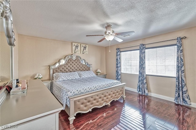 bedroom with baseboards, visible vents, dark wood finished floors, ceiling fan, and a textured ceiling