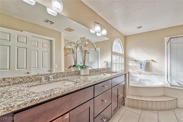 bathroom featuring double vanity, a sink, and visible vents