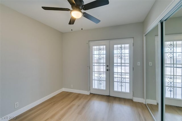 doorway to outside featuring french doors, plenty of natural light, light wood-style floors, and baseboards