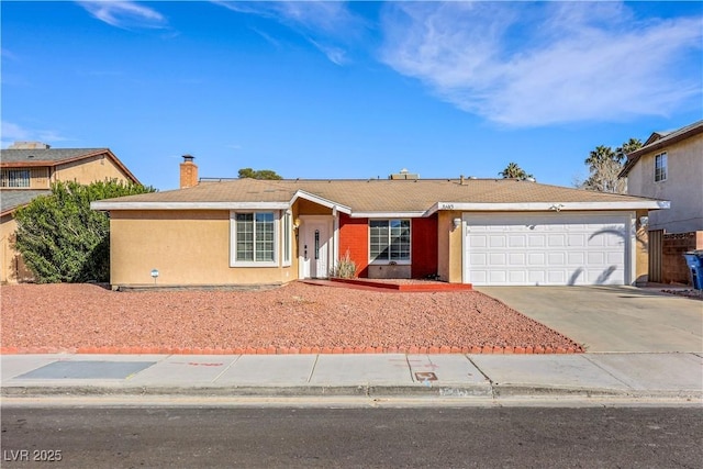 single story home with concrete driveway, an attached garage, and stucco siding