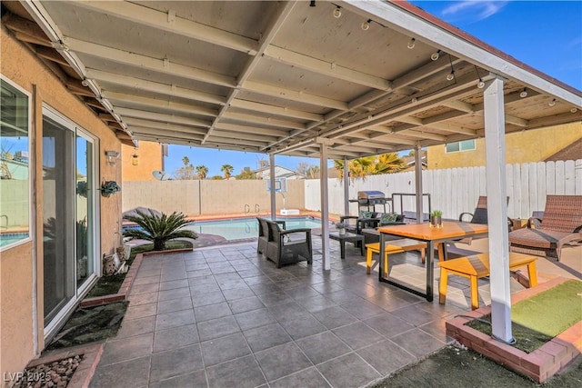 view of patio / terrace featuring outdoor dining area, a fenced backyard, and a fenced in pool