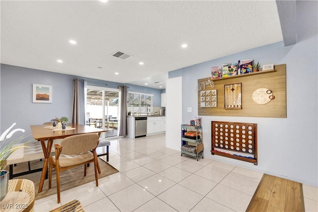 dining space featuring recessed lighting, visible vents, a textured ceiling, and light tile patterned floors