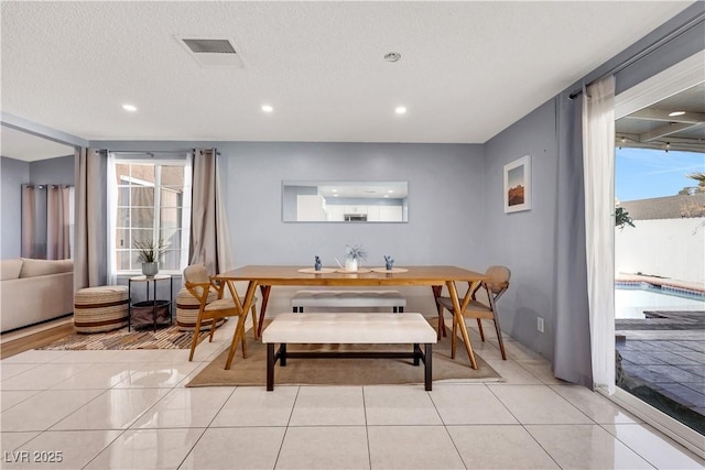 dining room with light tile patterned floors, visible vents, a textured ceiling, and recessed lighting