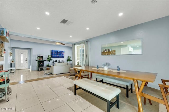 dining area featuring light tile patterned floors, visible vents, a textured ceiling, and recessed lighting